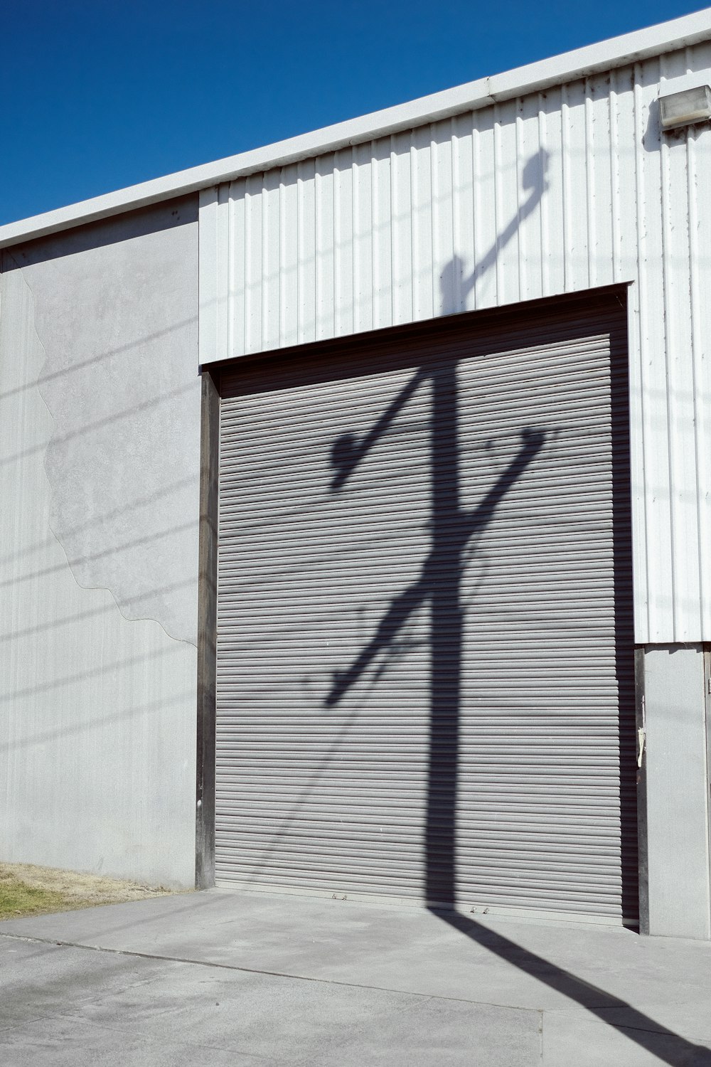 the shadow of a street light on a garage door
