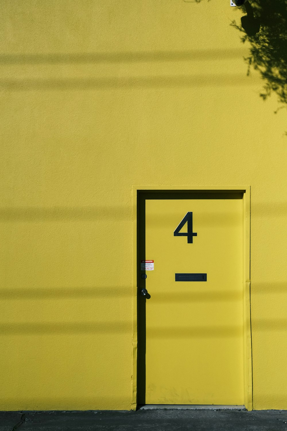 a yellow door with a number four on it