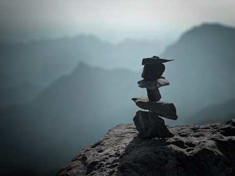 a stack of rocks sitting on top of a mountain
