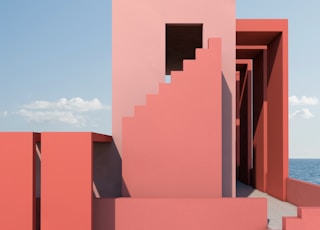 a pink building with stairs leading up to it