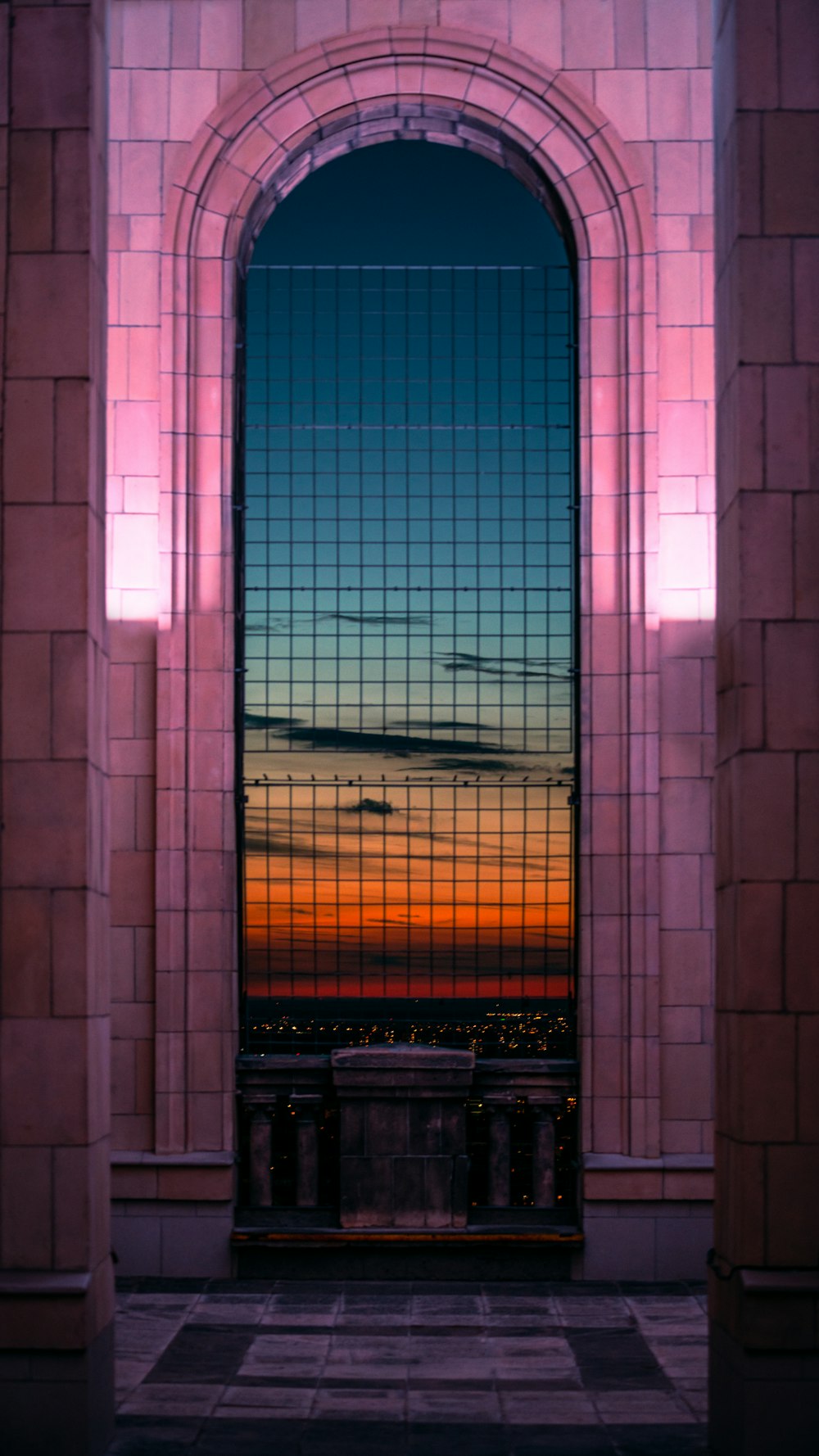 a large window with a sunset in the background