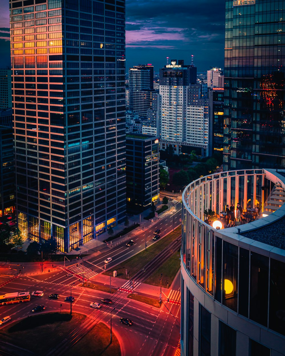 a view of a city at night from the top of a building