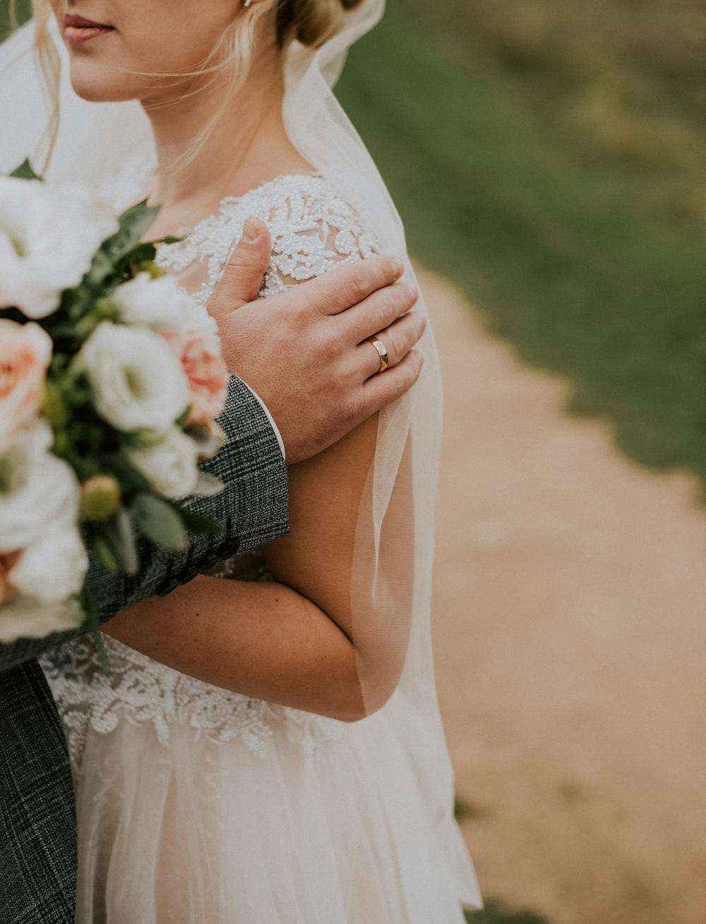 a bride and groom embracing each other on their wedding day