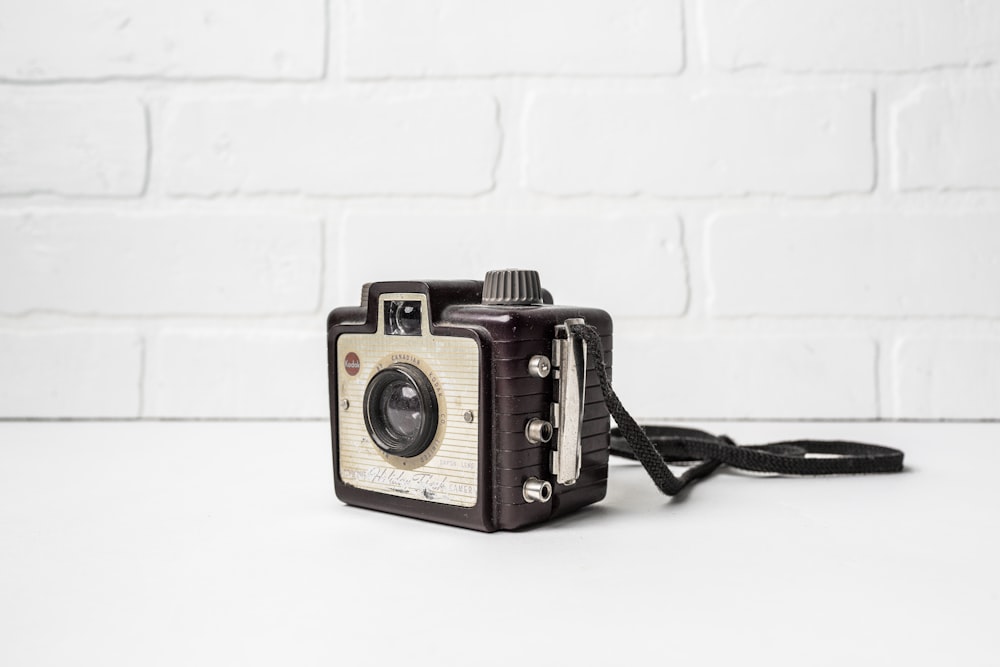 a brown and white camera sitting on top of a table