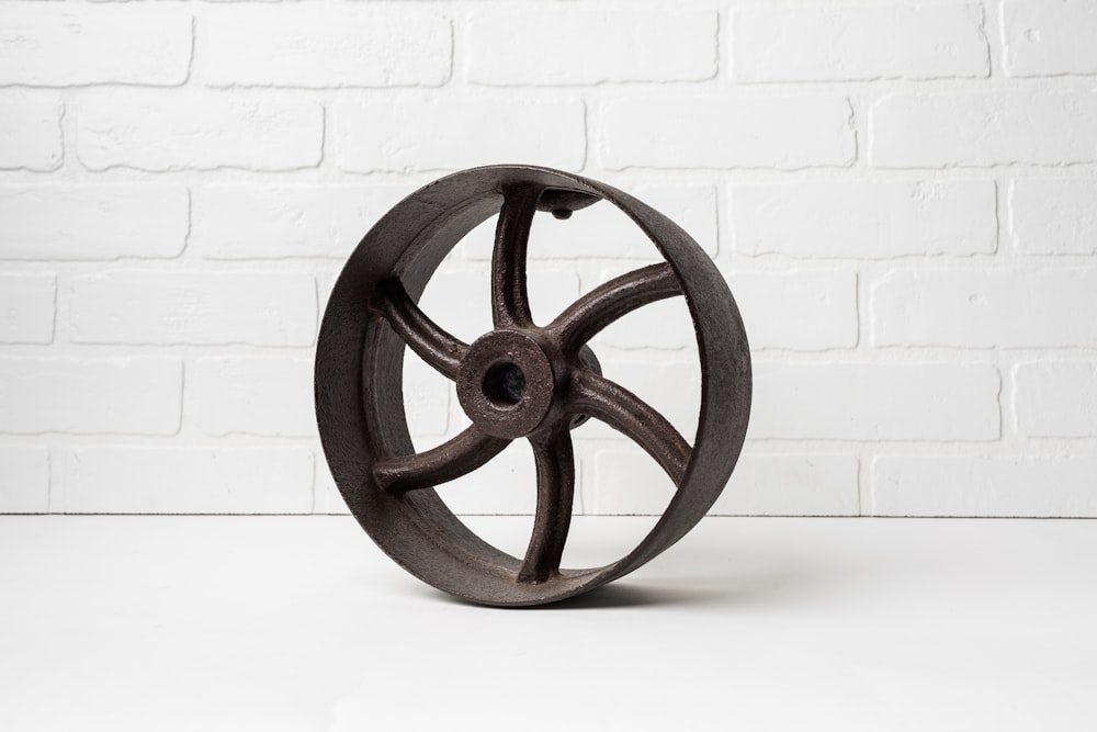 a metal wheel on a white table