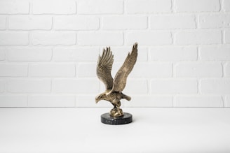 A vibrant metal wall art piece of a soaring eagle in a rich bronze finish.