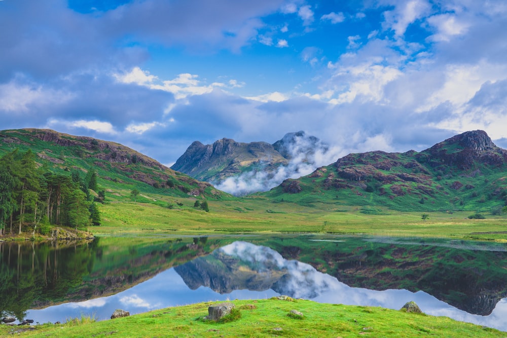 Une chaîne de montagnes avec un lac au premier plan