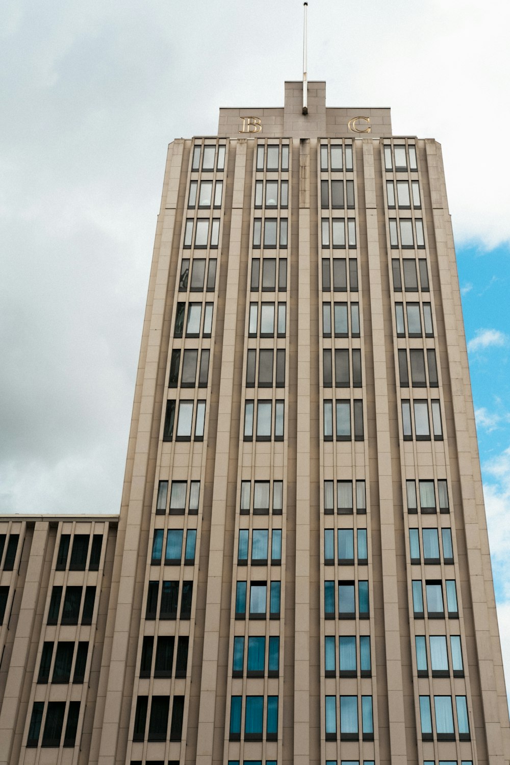 a tall building with a flag on top of it