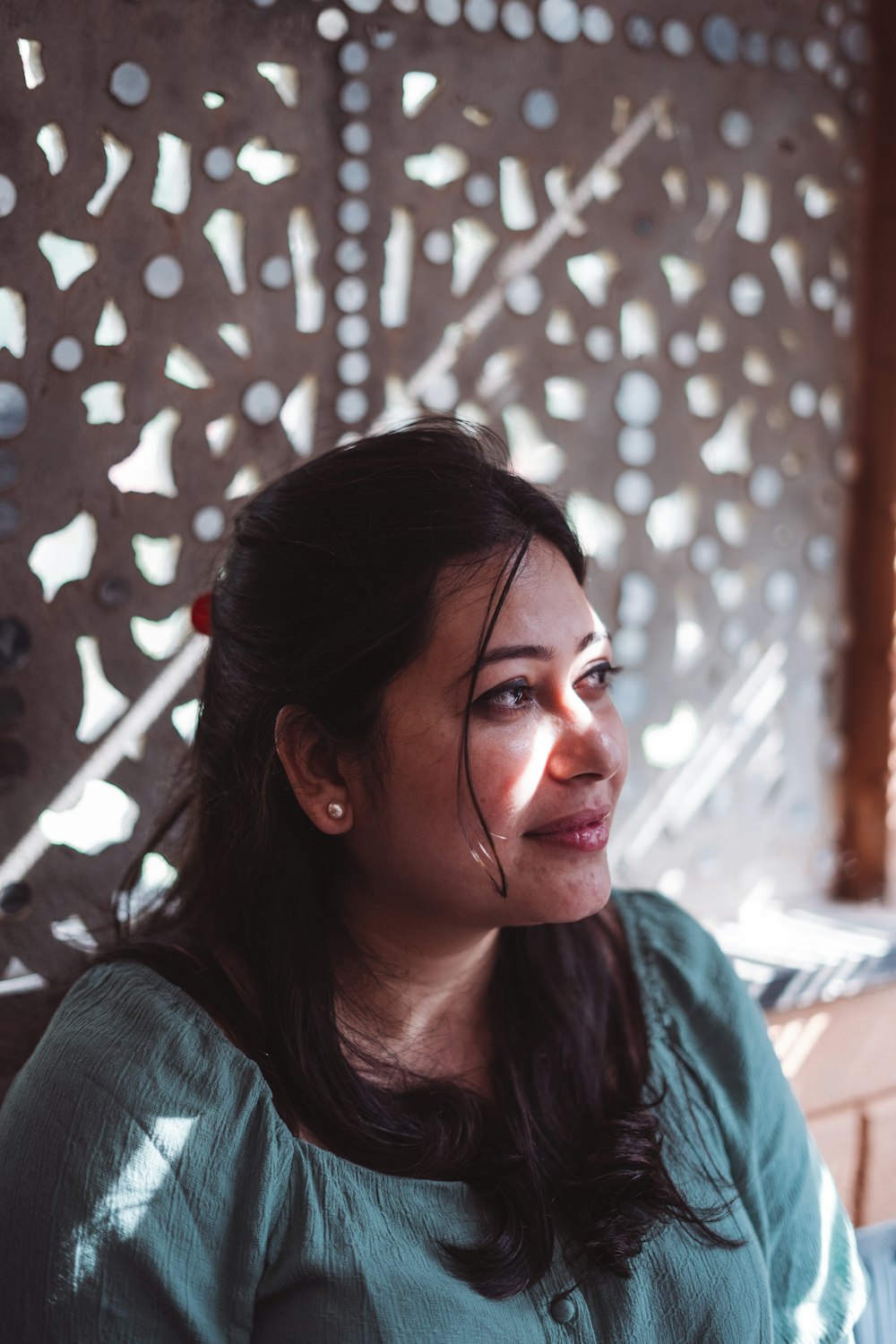 a woman sitting in front of a wall