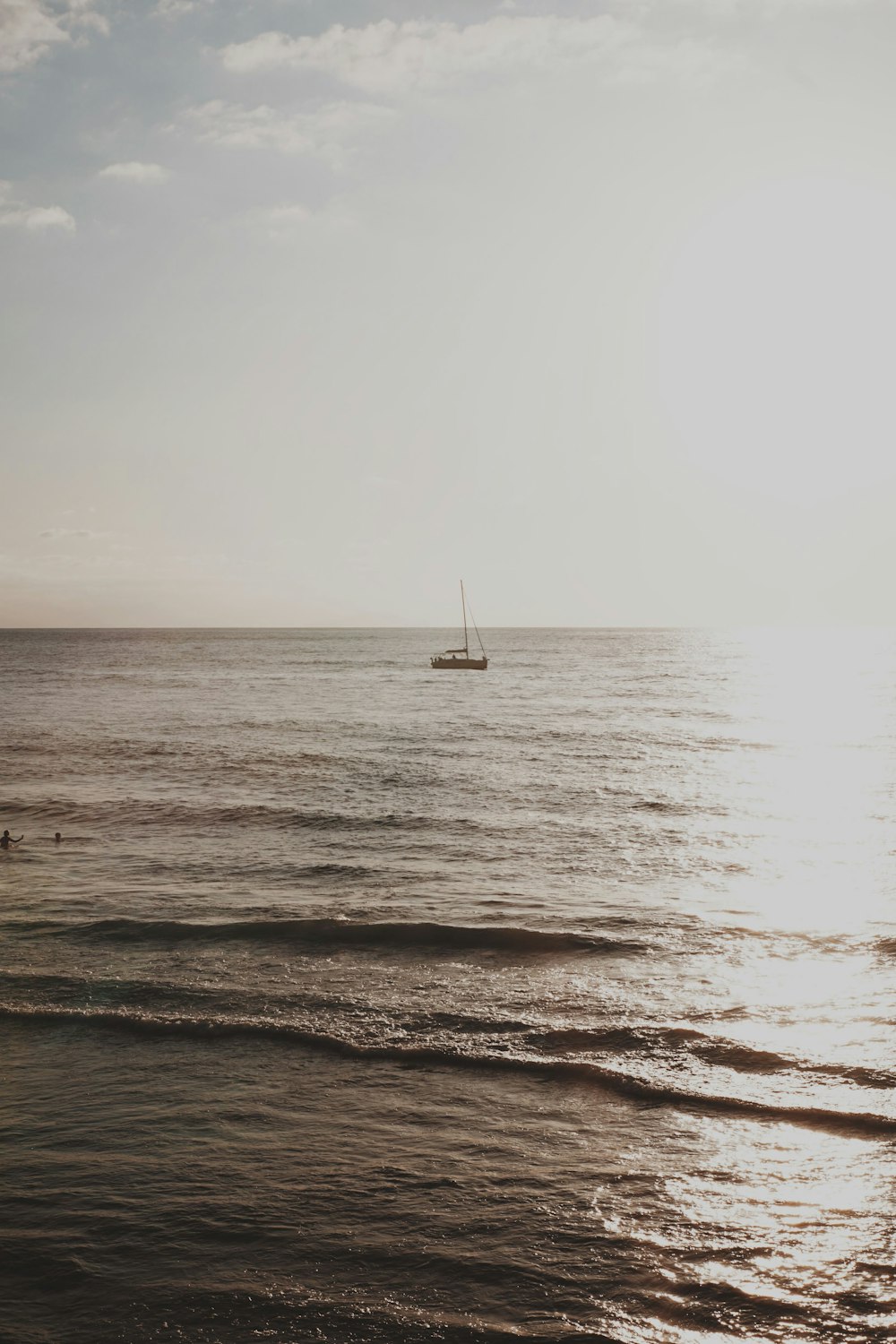 a boat is out in the ocean on a sunny day