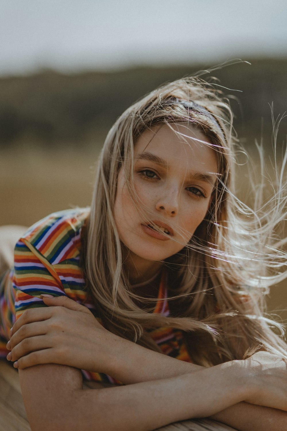 a woman with her hair blowing in the wind