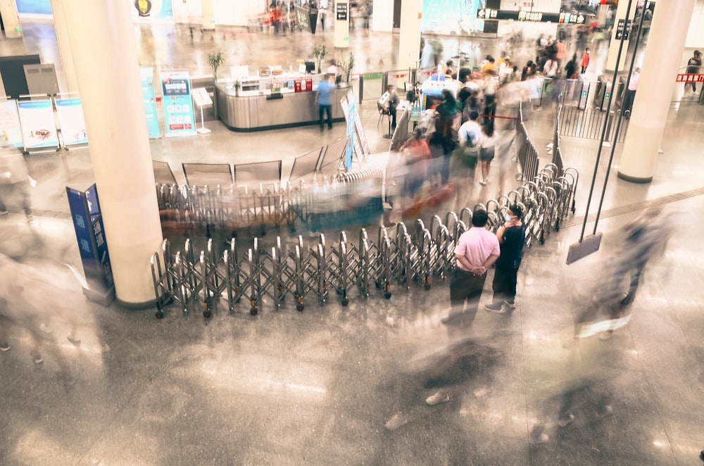 a blurry photo of people walking through an airport