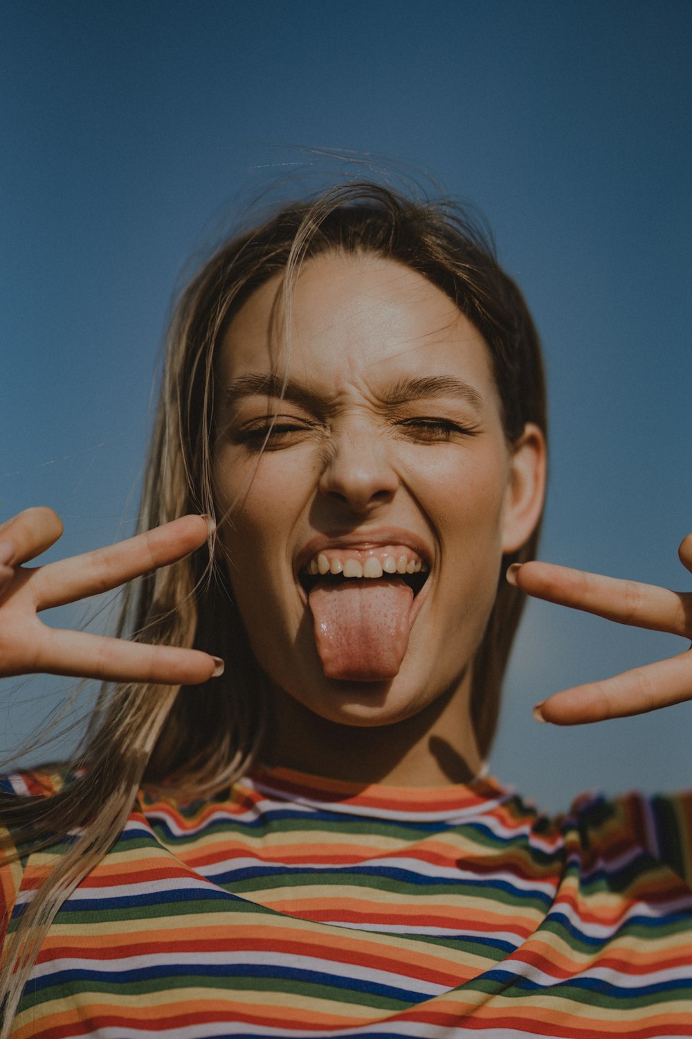 a woman making a funny face with her hands