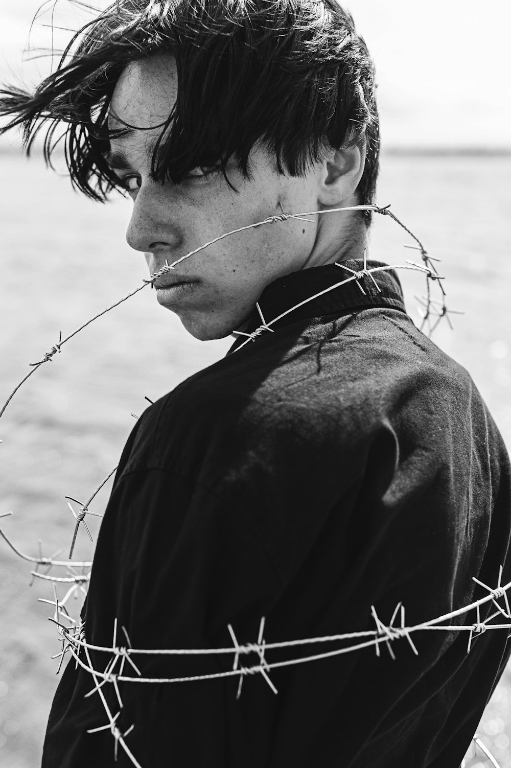 a man with barbed wire around his neck