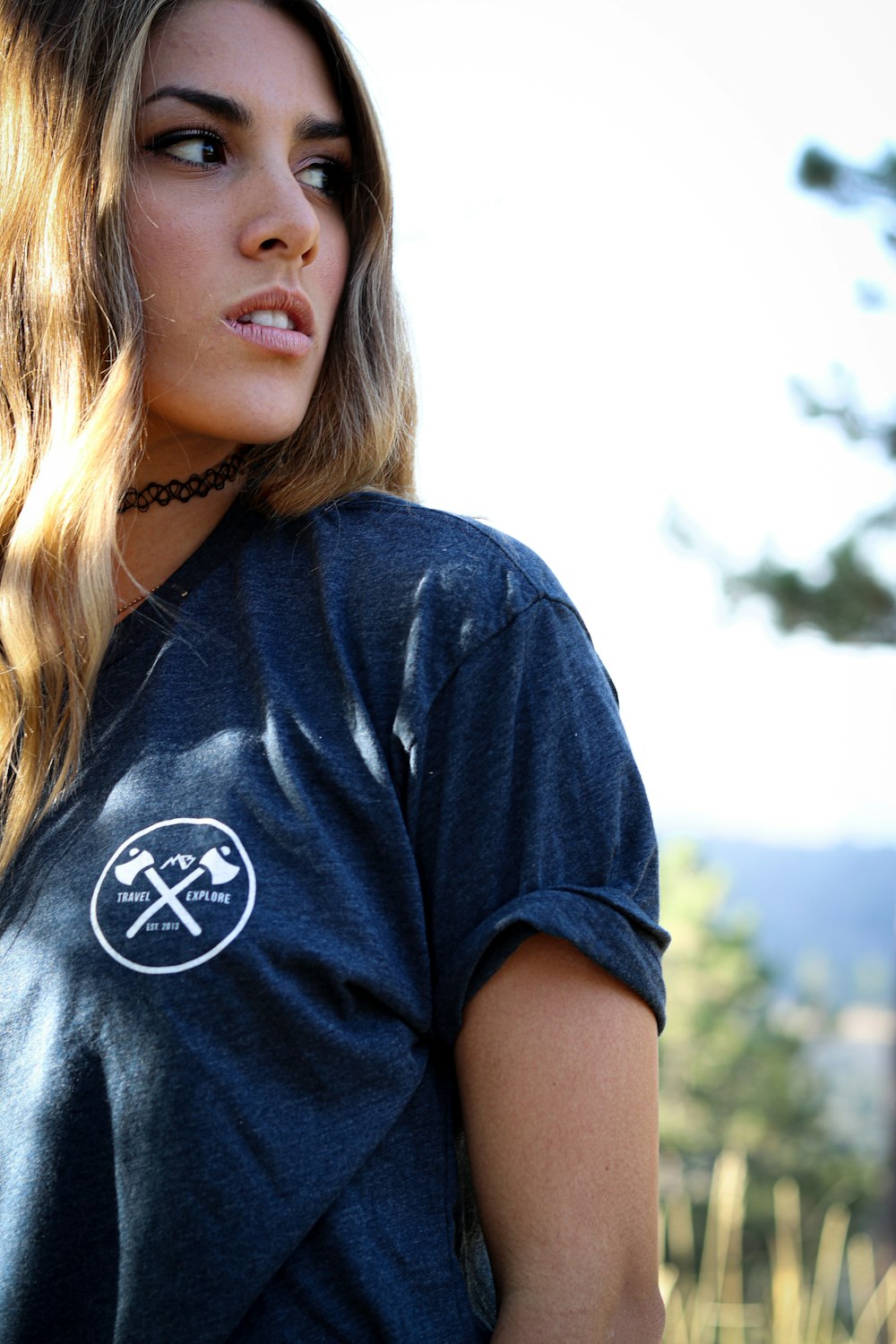 a woman with long hair wearing a blue shirt