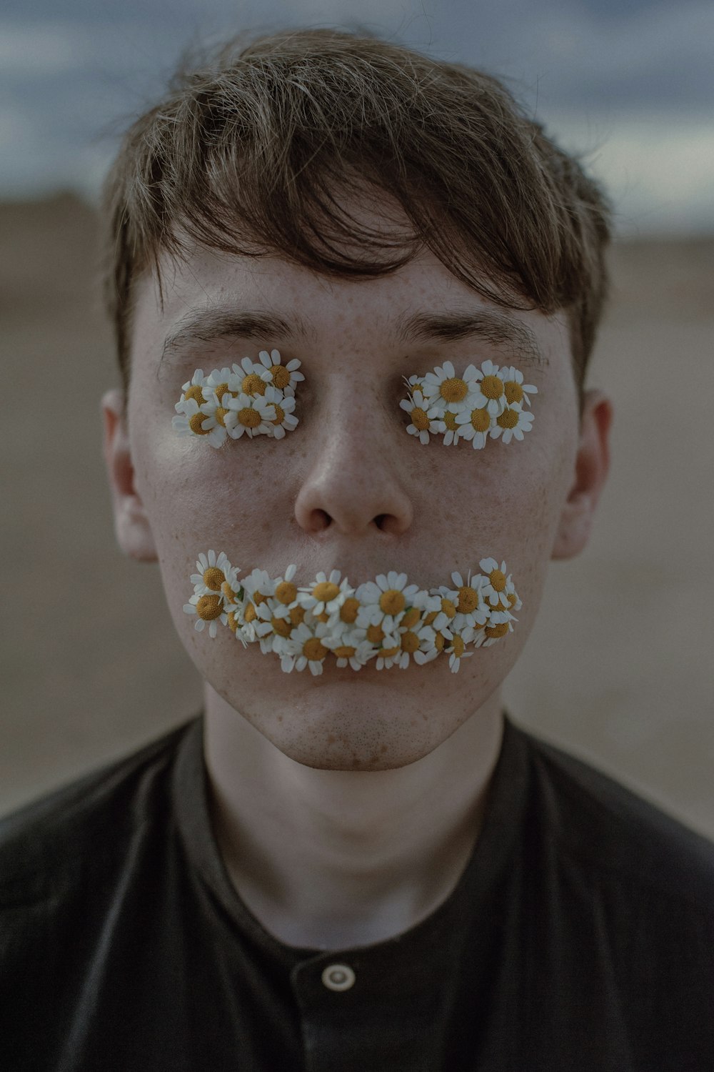 a man with flowers painted on his face