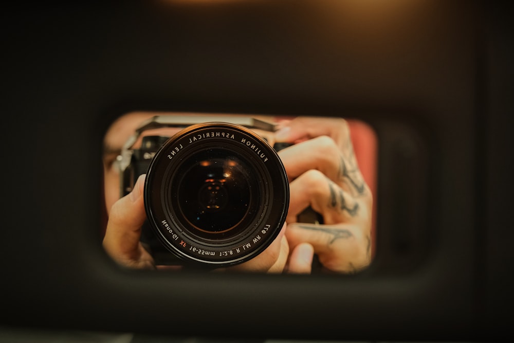 a person taking a picture of themselves in a mirror