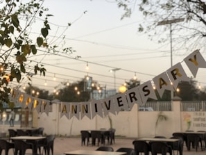 a party banner hanging over a table in a restaurant