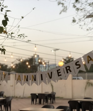 a party banner hanging over a table in a restaurant