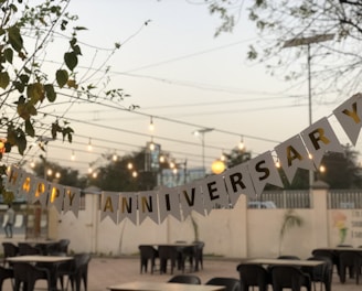 a party banner hanging over a table in a restaurant