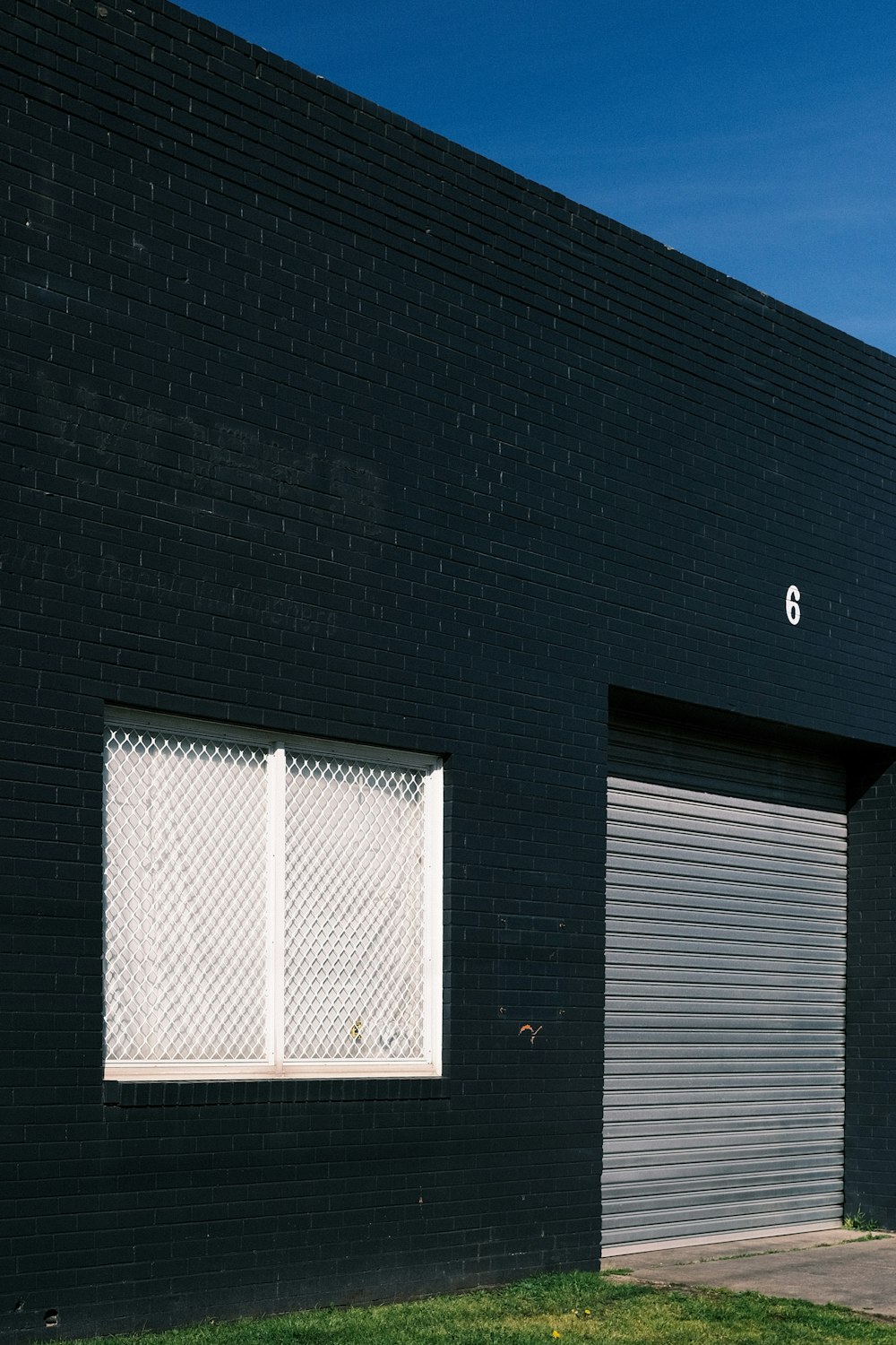 a fire hydrant in front of a black building