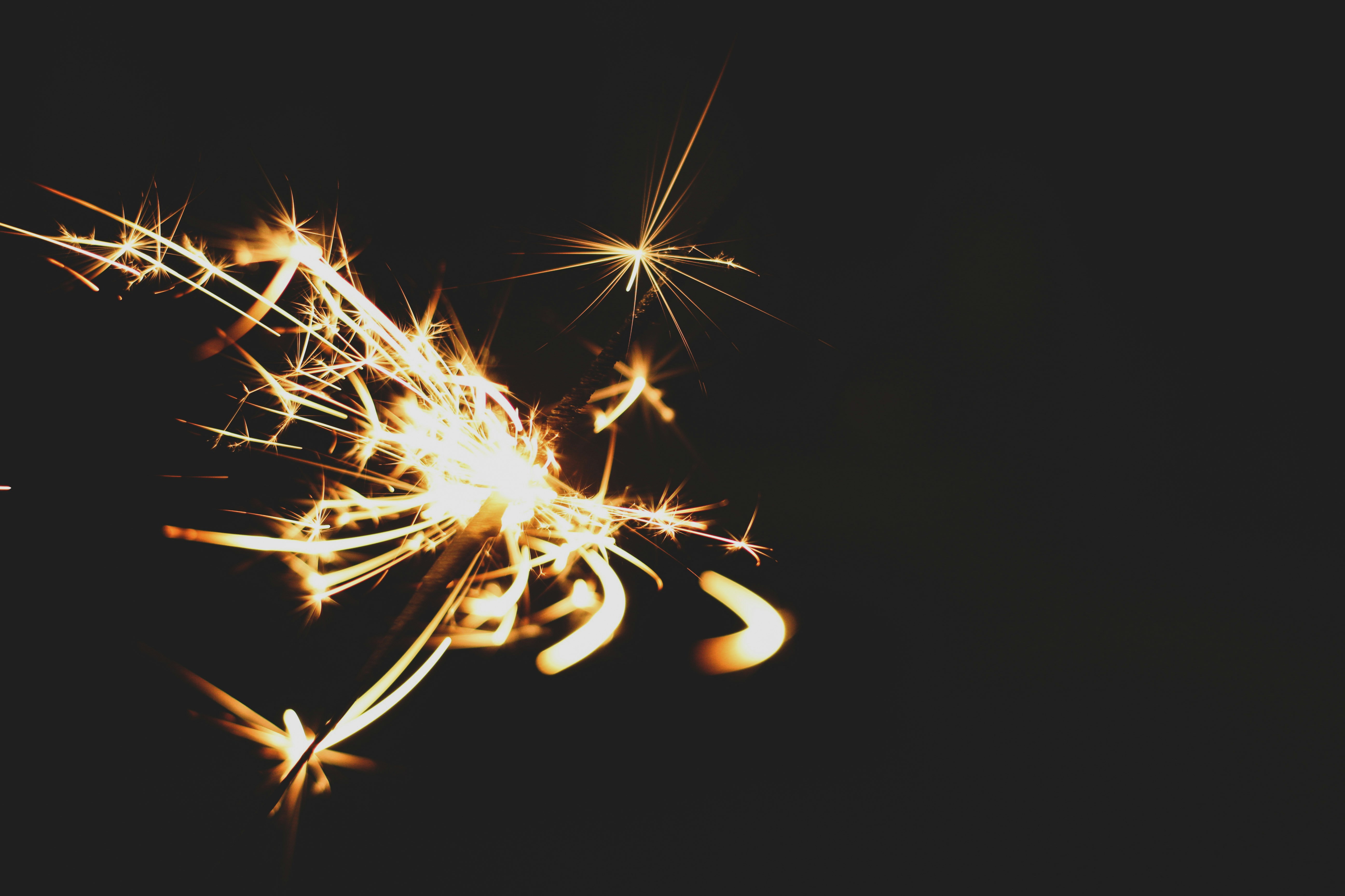 a close up of a sparkler on a black background