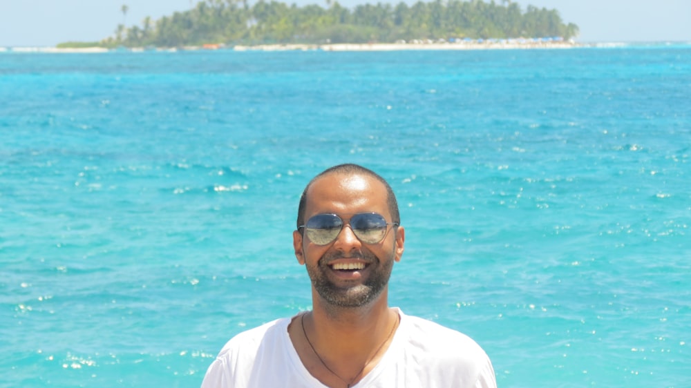 a man standing in front of a body of water