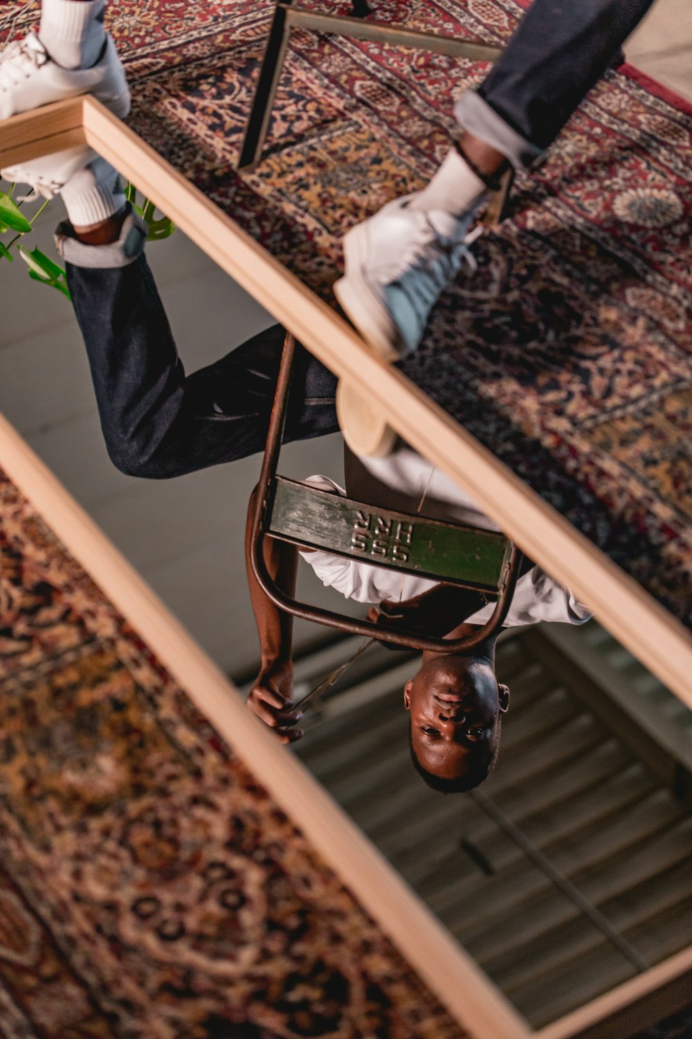 a man is hanging upside down on a skateboard