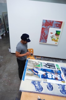 a man is working on a painting in an art studio
