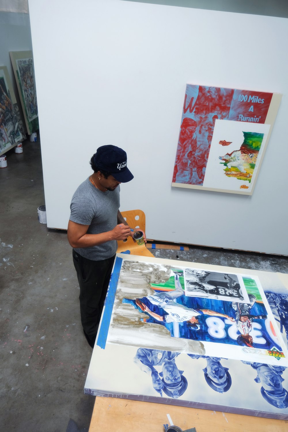 a man is working on a painting in an art studio