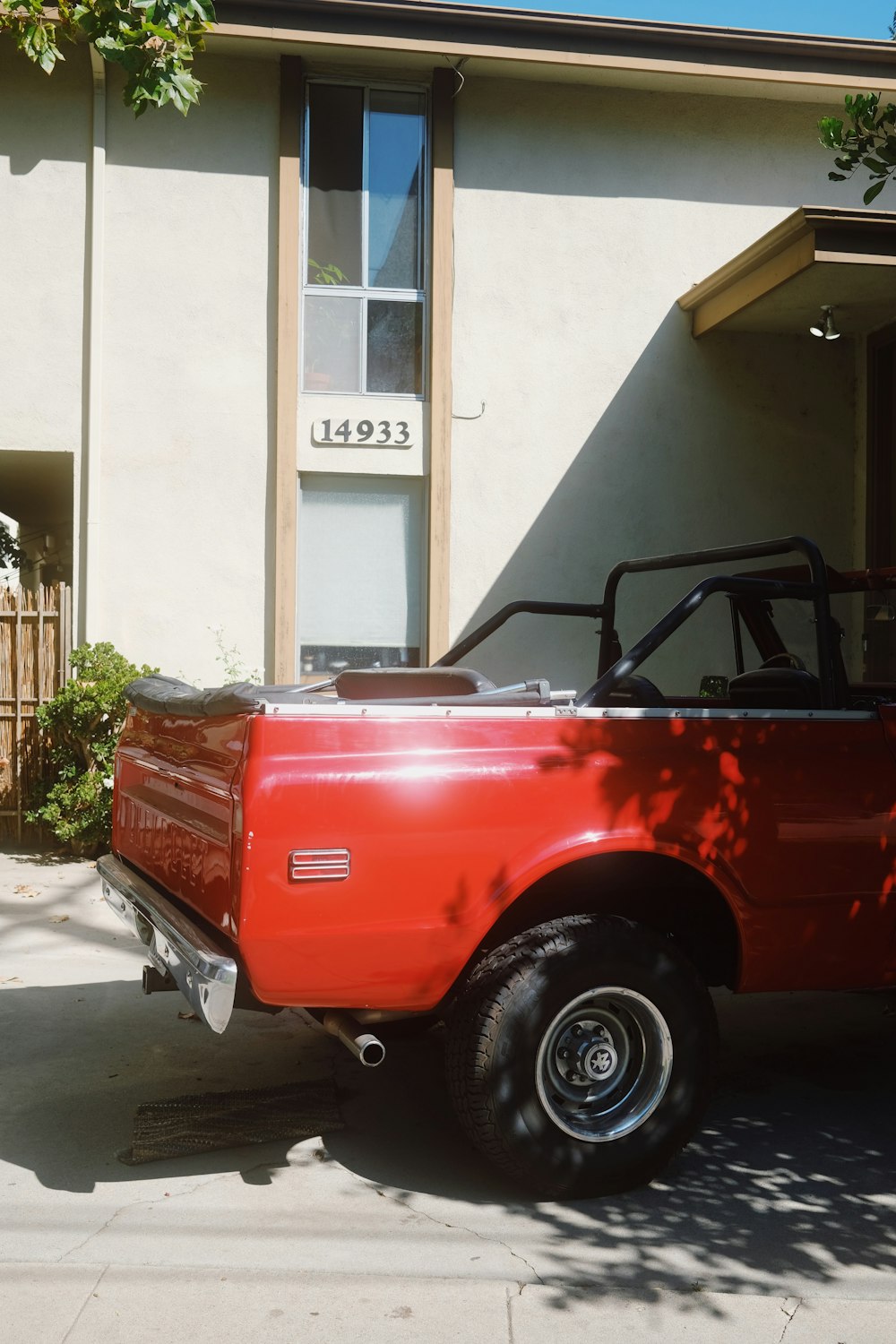 a red pick up truck parked in front of a building