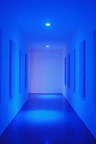 Sleek bathroom with glassmorphism design elements and glowing neon blue highlights.