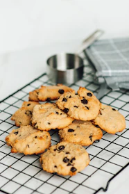 Freshly baked golden cookies cooling on a stylish baking sheet in a modern kitchen.