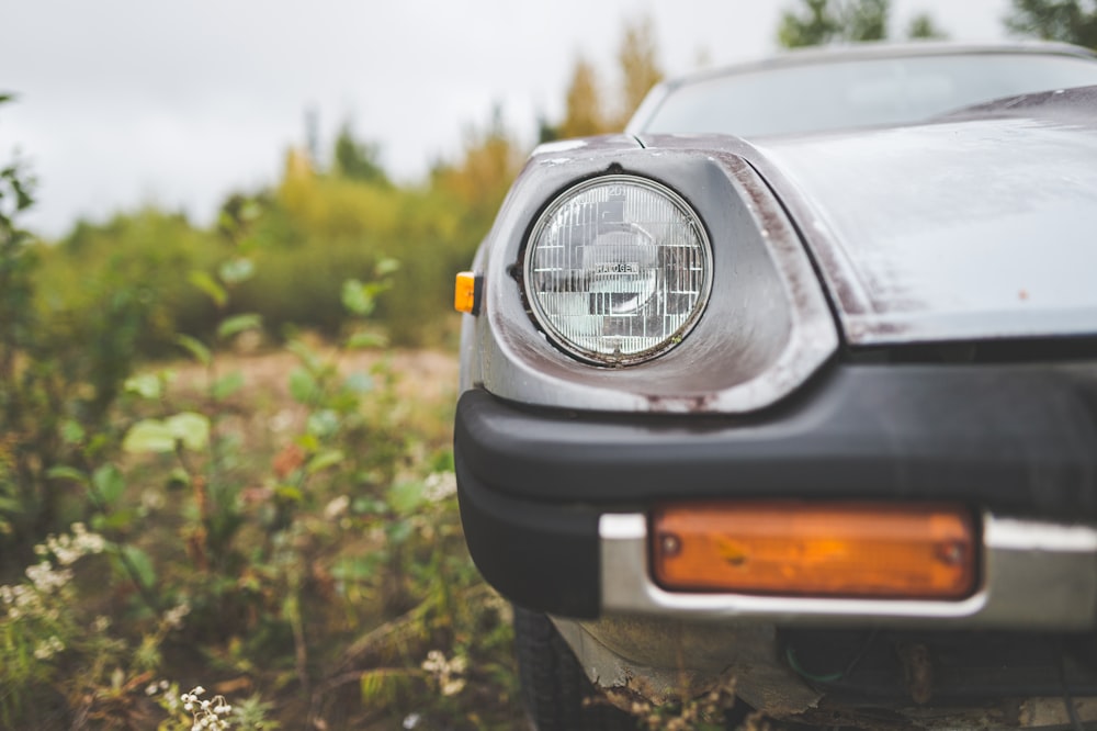a close up of a car parked in a field