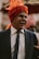 a man in a turban laughing and wearing a suit