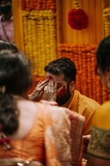 a man covering his face with his hands