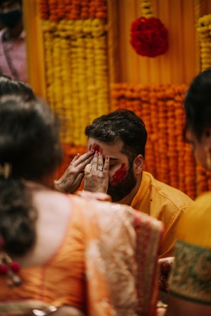 a man covering his face with his hands