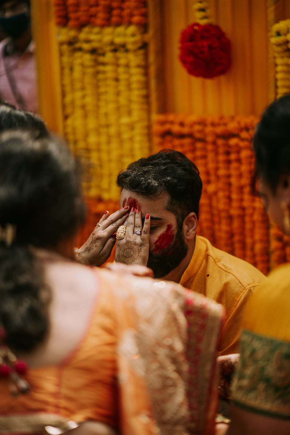 a man covering his face with his hands