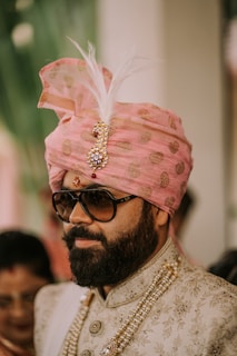a man wearing a pink turban and sunglasses