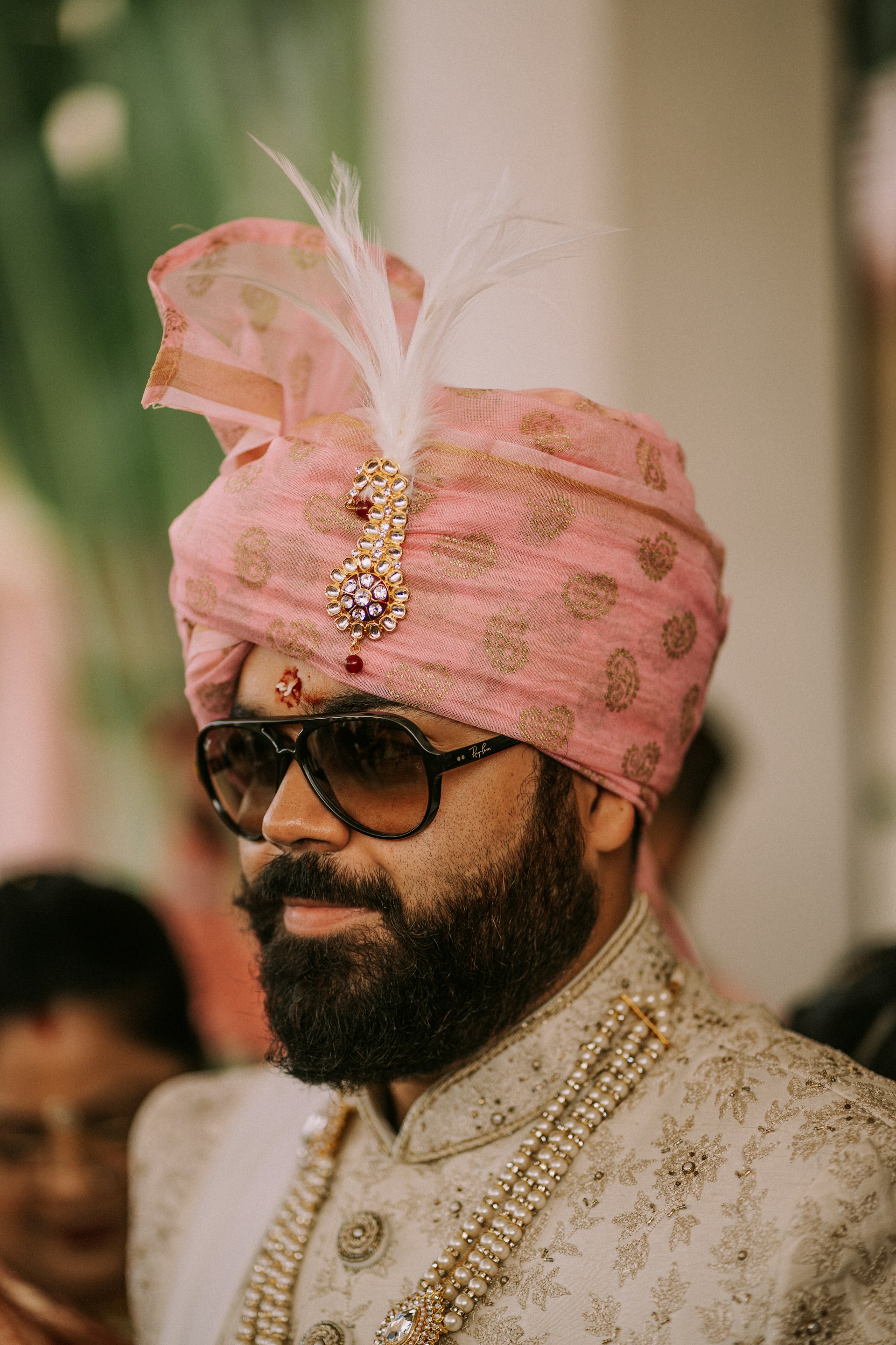 a man wearing a pink turban and sunglasses