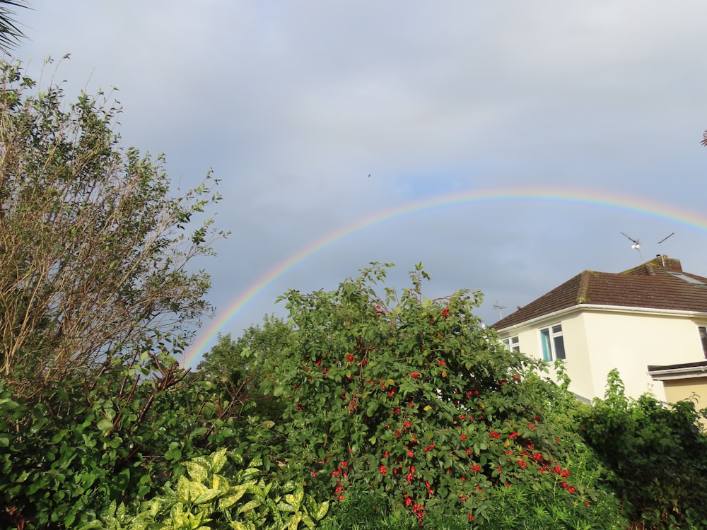 a rainbow in the sky over a house