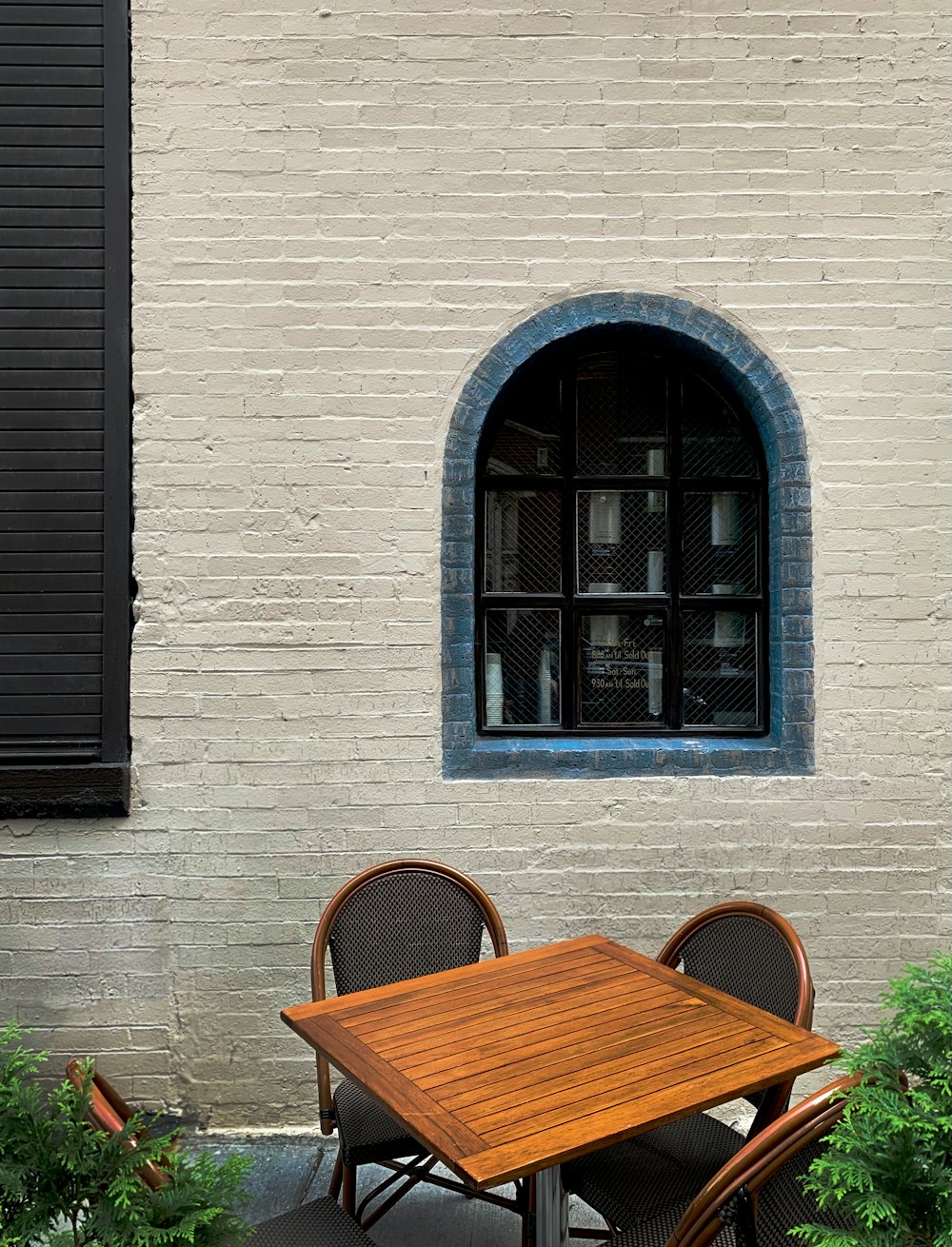 a table and chairs sitting in front of a window