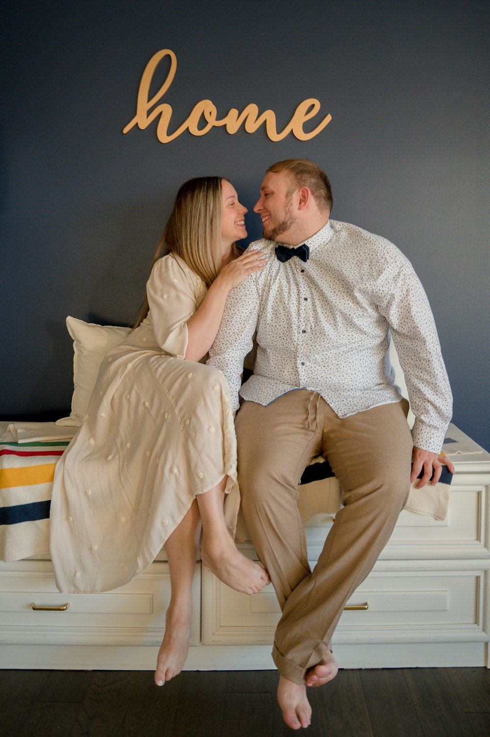 a man and a woman are sitting on a bed