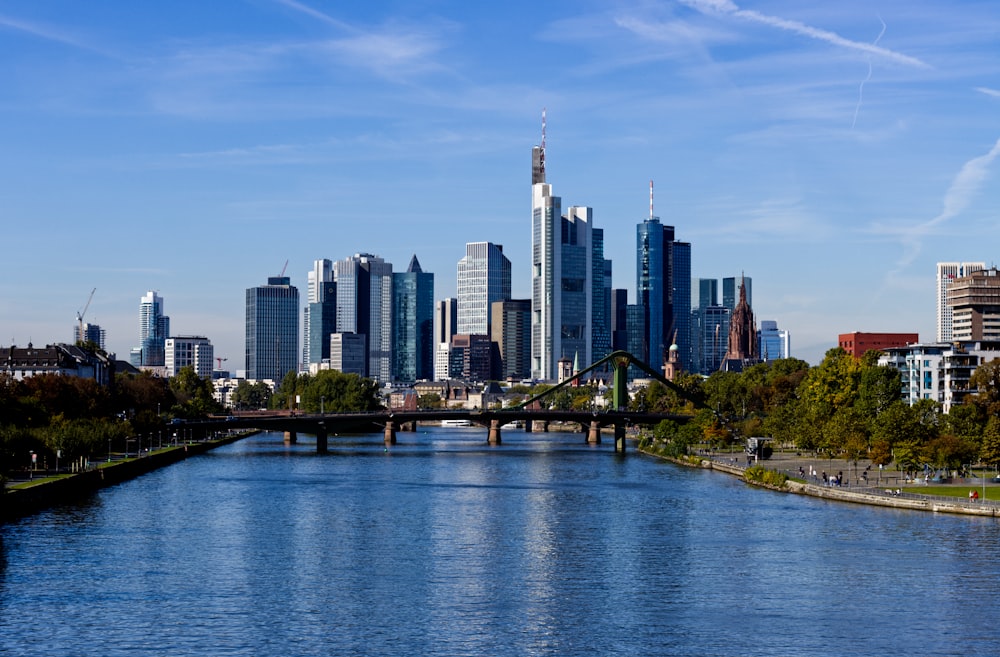 a river with a bridge and a city in the background