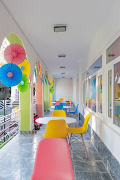 a long hallway with colorful chairs and tables