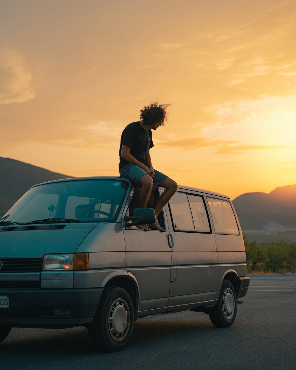 a person sitting on the roof of a van