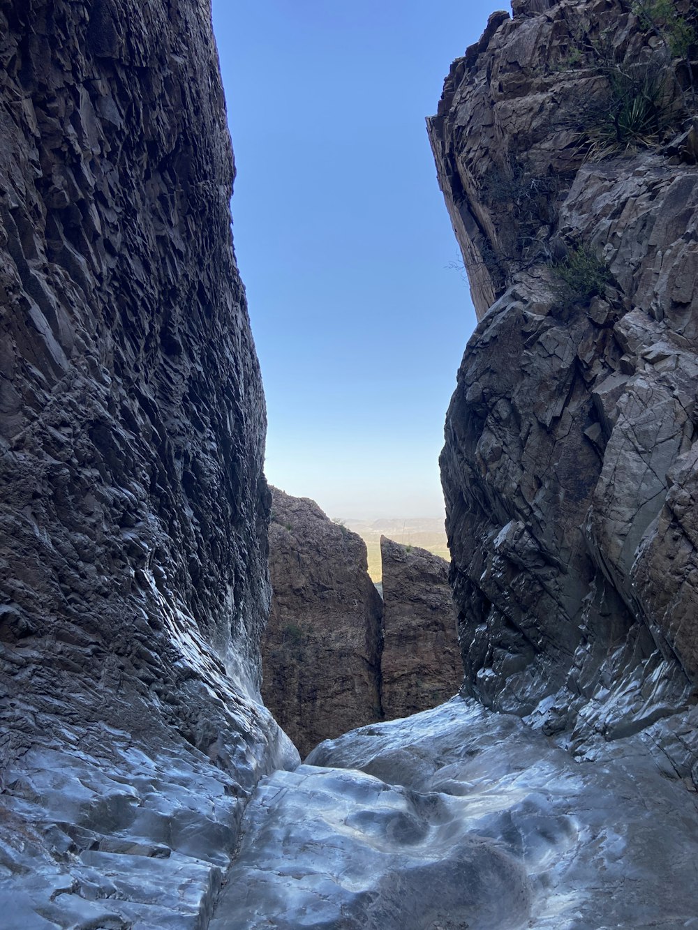 a view of a narrow mountain with ice on the ground