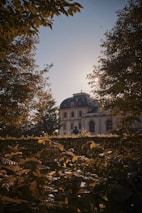 A serene exterior shot of a stately building bathed in warm afternoon light, symbolizing enduring prestige.