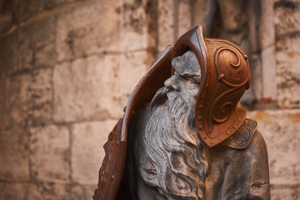 a statue of an old man wearing a helmet