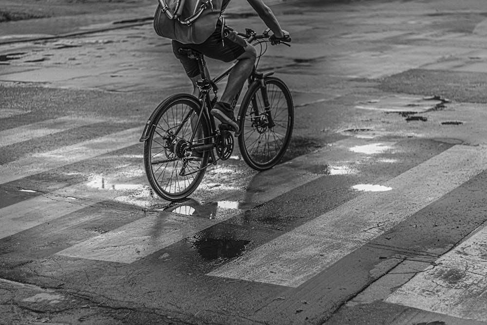 a man riding a bike across a street